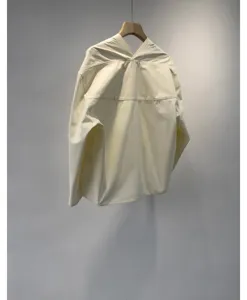 Detail view of off-white cotton V-neck shirt showing exquisite collar and shoulder.