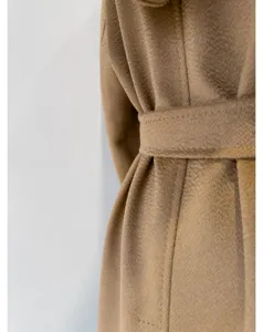 Camel wool coat fabric detail and belt close up view for autumn and winter daily fashion wear.
