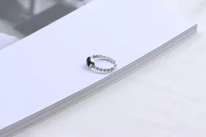 Detailed shot of Thai silver open ring featuring oval black agate, minimalist vintage style.