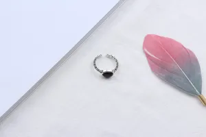 Exquisite Thai silver open ring featuring an elegant oval black onyx stone, minimalist style detail.