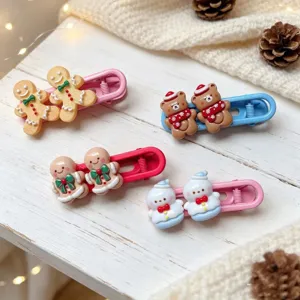 Cute Christmas hair clips set with gingerbread man and bear designs for sweet hairstyles detail.