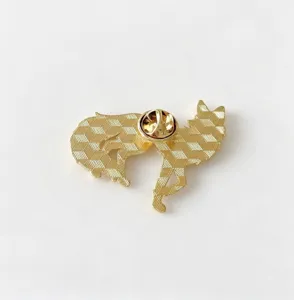 Close-up detail of the back of the golden geometric fox metal brooch with pin clutch.