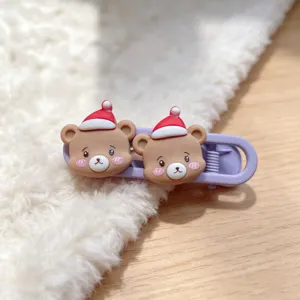 Detailed close-up of cute Christmas bear hair clip with soft furry and wooden background.