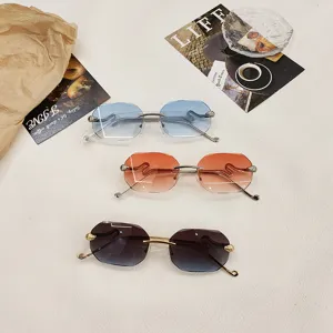 Rimless gradient sunglasses for women featuring stylish metal temples and unique vintage frames.