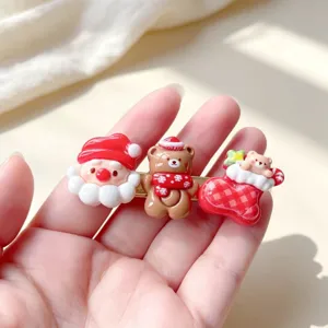 Jolie pince à cheveux de Noël avec pendentifs en résine de Père Noël et d'ours.