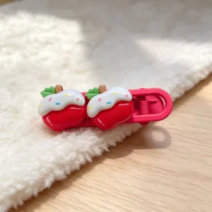 Cute pink hair clip detail featuring sweet frosted fruit design on cozy white fluffy background.