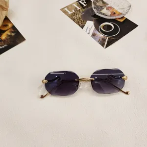 Rimless gradient polygon sunglasses with gold metal frame and snake-shaped temples for women