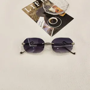 Stylish rimless faceted polygon sunglasses featuring luxury snake head metal temples for women.
