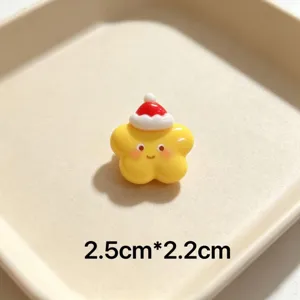 Close up detail view of cute cartoon star Christmas brooch with Santa hat, compact size ornament.