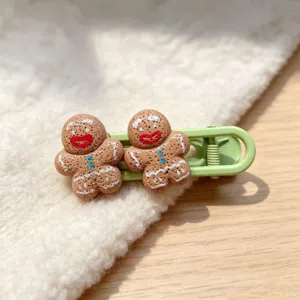 Close-up detail of cute gingerbread resin hair clip, sweet cartoon design for daily styling.