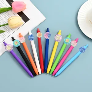 Detailed view of colorful gel pens with resin rose flower decor on blue surface.