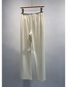 Detailed view of white pleated casual wide-leg pants with comfortable elastic waist.
