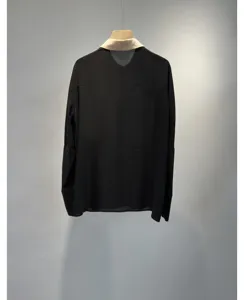 Detailed view of the elegant black long-sleeve shirt featuring a contrasting collar.