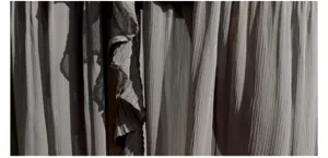 Grey pleated ruffle skirt fabric detail closeup shot showcasing soft texture and draping style.