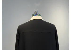 Detailed back view of women's black long sleeve acetate shirt with contrast silk collar.