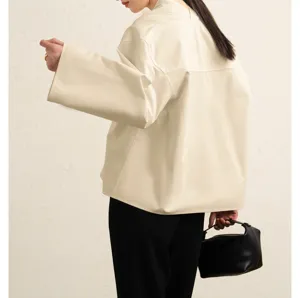 Detailed back view of a minimalist cream wide-sleeve short cotton poplin shirt with chic collar.