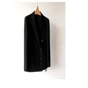 Detail view of a classic black double-breasted blazer jacket hanging on a wooden hanger.