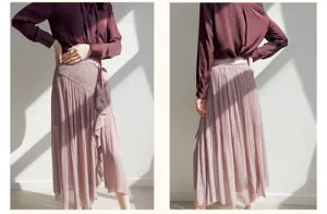 Detail view of the high-waist pink pleated split skirt with delicate ruffles and smocked waist.