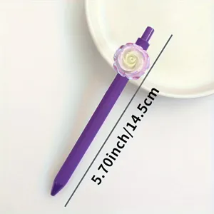 Detail view of a purple gel pen showcasing a lovely 3D iridescent camellia flower accent.