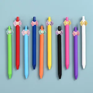 Detailed view of colorful gel pens featuring glossy translucent floral bow charms, cute stationery.
