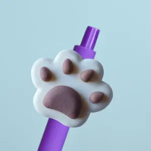 Close-up view of a cute purple gel pen featuring a 3D white and brown paw topper design.