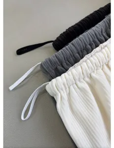 Corduroy air pants detail showcase featuring elastic drawstring waistband and soft fabric.