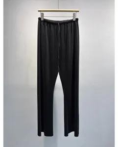 Black pleated wide leg pants detail showing lightweight drape fabric and elastic drawstring waist.