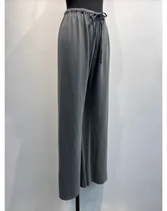 Detailed view of dark grey pleated wide-leg trousers with an adjustable drawstring waist.