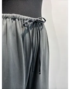 Gray pleated trousers detail, elastic waistband with black drawstring, elegant drape fabric.