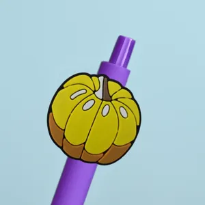 Close-up of cute yellow pumpkin patch decoration on purple gel pen, Thanksgiving stationery.
