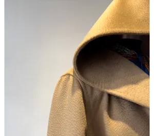 Camel hooded wool coat detail, premium zibeline texture fabric for winter warmth and style.