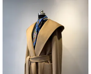 Detailed view of the camel hooded wool coat showcasing the wrap design and matching belt style.