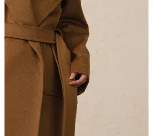 Close up detail of camel wool wrap coat belt and fabric texture, elegant winter apparel feature.