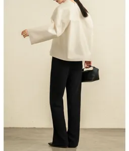 Minimalist mandarin collar loose sleeve shirt with elegant black trousers detail view style
