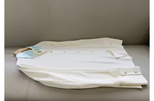 White long sleeve shirt featuring a light blue contrast silk collar and front button closure.