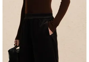 Corduroy pants detail shot, showing high waist and soft texture, elegant autumn style.
