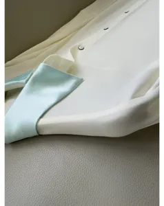 Elegant contrast collar shirt detail, smooth acetate fabric, luxurious long sleeve fashion style.