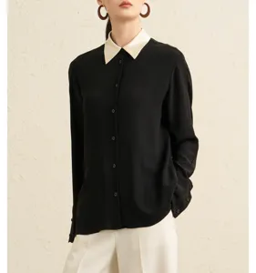 Detail shot of women's black long-sleeve blouse featuring a contrast cream collar.