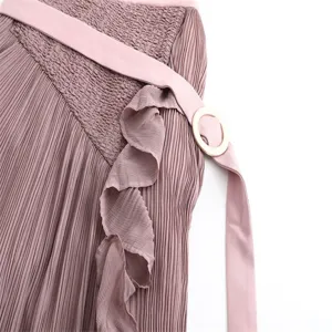 Detailed view of women high waist pleated skirt with belt and ruffle accent. Spring style.
