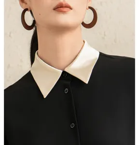 French contrast silk collar blouse detail view, elegant women's black shirt with unique collar.