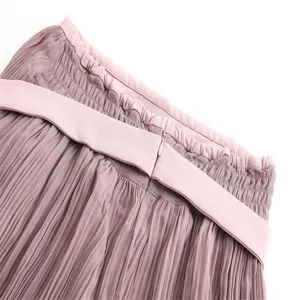 Micro-pleated high-waisted midi skirt detail, elegant pink pleated fabric with belt.