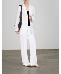 Gedetailleerd overzicht van lichte zomerse witte damesblazer, ademende premium stoftextuur.