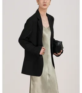 Gedetailleerd overzicht van het lichte zomerse damesblazer gecombineerd met jurk.