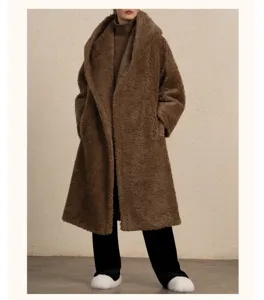 Details of the long brown wool teddy coat with a cozy hood, showcasing plush texture.