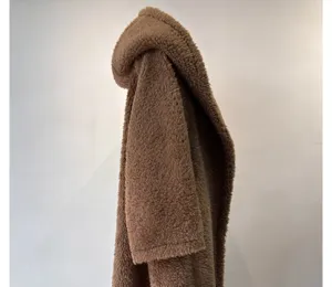 Brown teddy fleece hooded coat detail shot, soft plush fabric and cozy winter warmth.