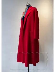 Detail view of the red cashmere bathrobe coat showcasing fine fabric texture and patch pocket.