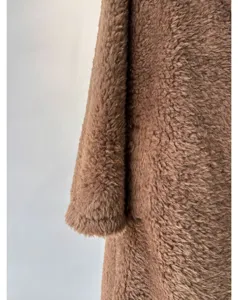 Cozy brown fleece teddy coat detail view, warm winter wool blend fabric texture shot.