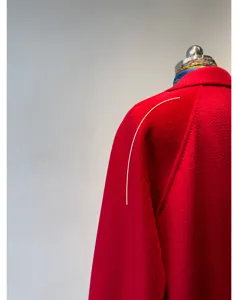 Red cashmere double-faced wrap coat detail, featuring premium water ripple fabric and shoulder cut.