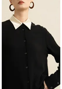 Elegant black long sleeve blouse featuring a contrasting silk collar and front button closure.