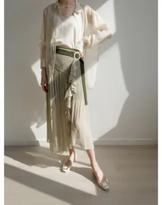 Detailed view of women's high-waist pleated split midi skirt with ruffle and belt design.